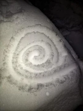 Spiral Pattern Drawn in Clean White Snow Close Up at Night 스톡 사진
