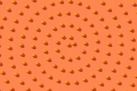 Spiral pattern of fresh orange fruit on an orange background Stock Photos