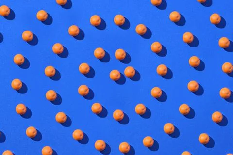 Spiral pattern of orange fruit isolated on a blue background Stock Photos