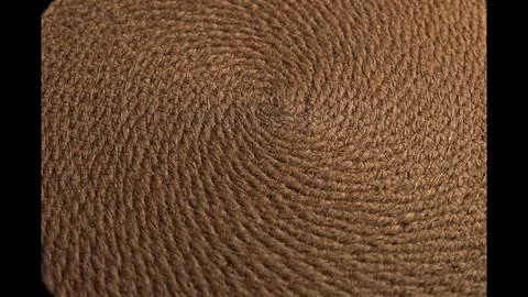 Spiral pattern reveals rough, braided fibers with tactile texture. Light Stock Photos