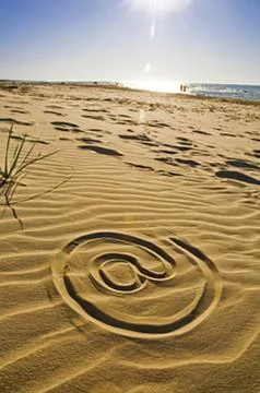 Spiral pattern in sandy beach with ocean Stock Photos