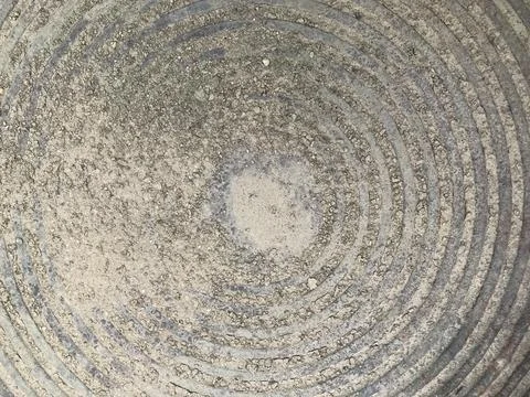 A spiral shape of gray cement floor and little dust and pebbles Stock Photos