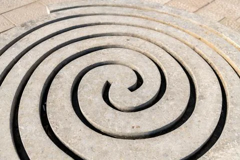Spiral shaped stone pattern with grooves Stock Photos
