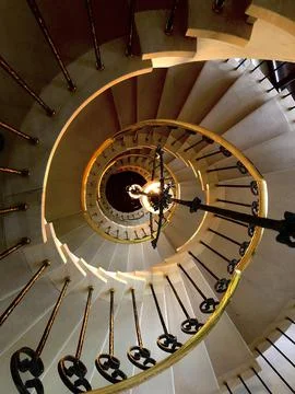 Spiral staircase, hanging lights, elevated view Stock Photos