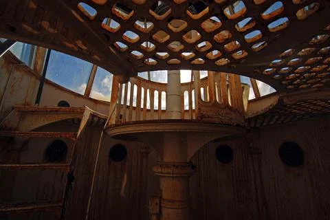 A spiral staircase winds dramatically inside a historic lighthouse Stock Photos