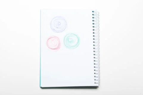 Spiral white notepad with pen scribble isolated on white background Stock Photos