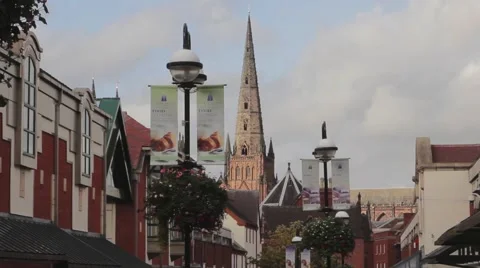 The Spire of Lichfield Cathedral Towering above Roof of Shopping Mall 動画素材 42906893