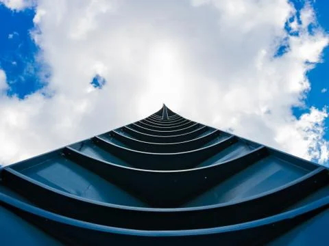 Spire pointing at partially cloudy sky. Stock Photos