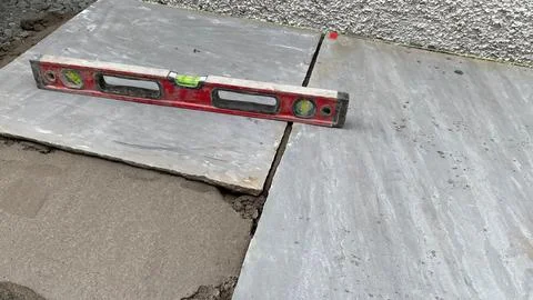 Spirit level on groundwork, precision leveling for landscaping installation. Stock Photos