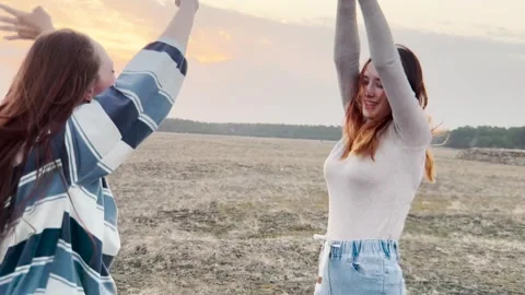 Spirited friends dancing and smiling, the magic of movement captured, nature s Stock Footage 311897295