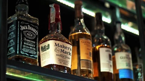 Spirits Alcohol Bottles on Shelf Vídeo Stock 128492830