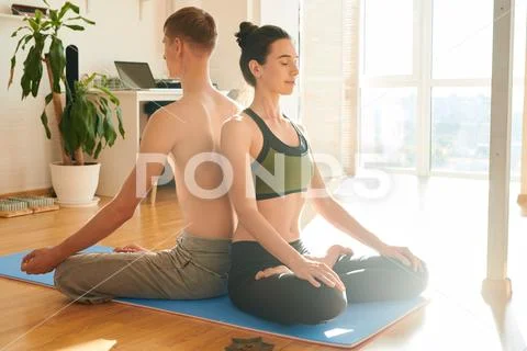 Spiritual couple meditating together at home Stock Photos