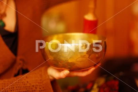 Spiritual girl immersed in meditative sounds of tibetian bowl. Stock Photos