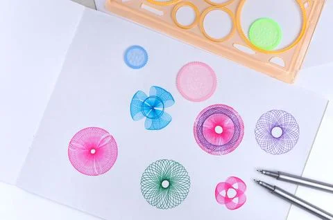 Spirograph ruler on white background. Drawing the spirograph pattern Stock Photos