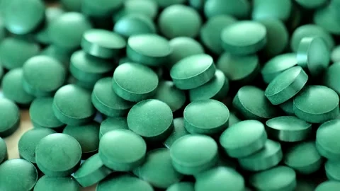 Spirulina algae tablets , rotating slowly.Supplements for health and longevity. Vidéo 277837323