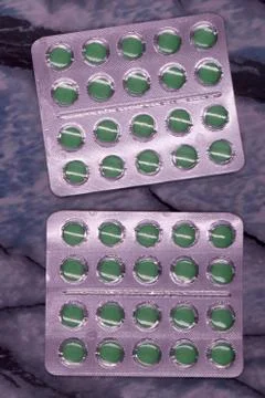 Spirulina tablets algae nutritional supplement heap surface close up top view Stock Photos