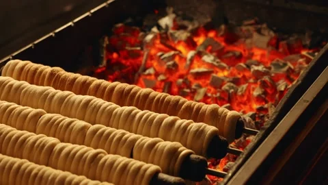 Spit Cake Cooking Over an Open Fire Using Charcoal Stock Footage 328062059