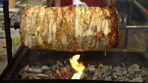 Spit meat. Meat on a horizontal skewer. Slices of meat are strung on the hoe Stock Footage 106899596