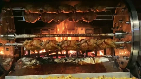 Spit roasted chickens are cooking in an oven, grill 2 Stock Footage 200856366