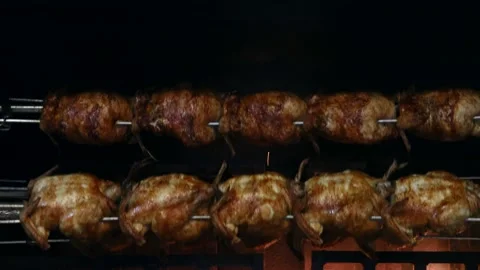 Spit roasted chickens are cooking in an oven, Grill Close up Stock Footage 201314055