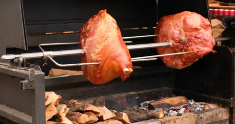 Spit roasting pork legs 스톡 동영상 97764549