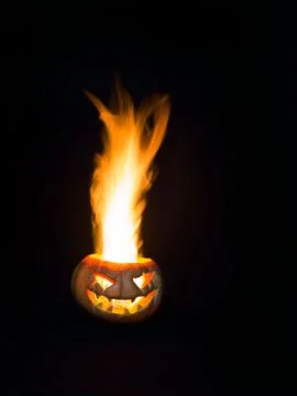 Spitefully smiling head made of pumpkin. A great real flame. 写真素材