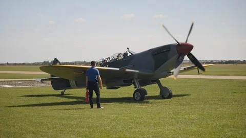 A Spitfire's propellers turn as the engine starts in slow motion Stock Footage 115058315