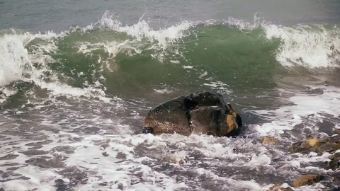 Splash against a wave on a stone slow motion Stock Footage 82930003