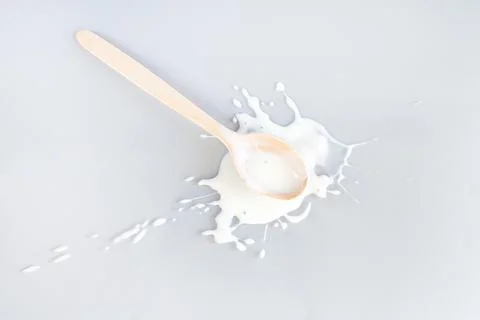 Splash and drops spill dressing with wooden spoon Stock Photos