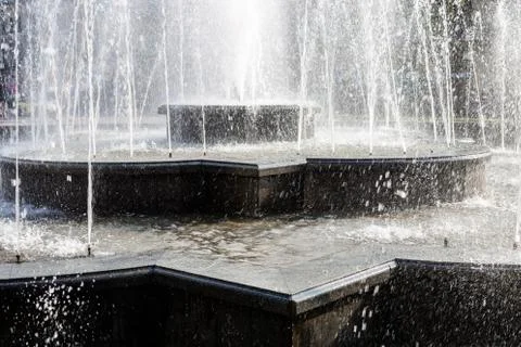 Splash and drops in a spring fontain. Stock Photos