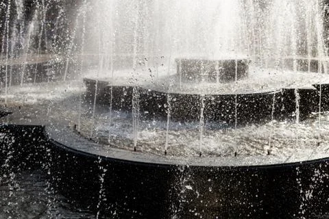 Splash and drops in a spring fontain. Stock Photos