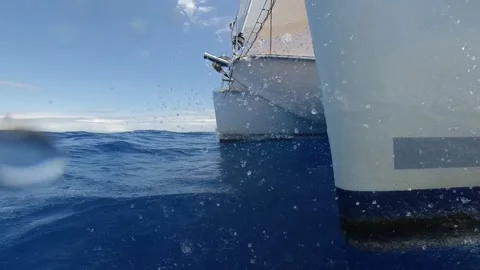 Splash on the bow of a catamaran sailboat in speed - Close-up shot Slow Motion Stock Footage 133464755