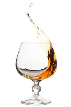 Splash of brandy in glass. Stock Photos