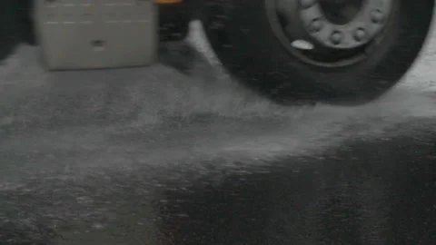 Splash by a car as it goes through flood water. Car driving on urban roads in Stock-Footage 118698720