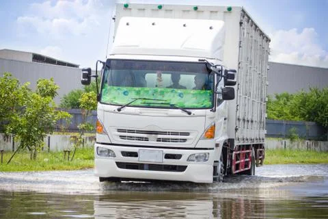 Splash by a car as it goes through flood water 스톡 사진
