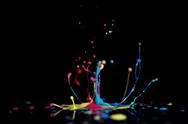 Splash Of Colorful Liquid Paint On A Black Background Paint Splash On Black  Stock Photos
