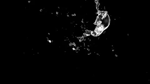 Splash of a drop in zero gravity on a black background. Stock Footage 305169412
