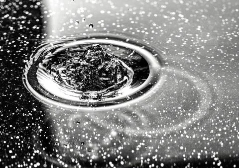 Splash - a falling drop of water in a macro photography shot Stock Photos