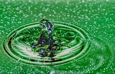 Splash - a falling drop of water in a macro photography shot Stock Photos