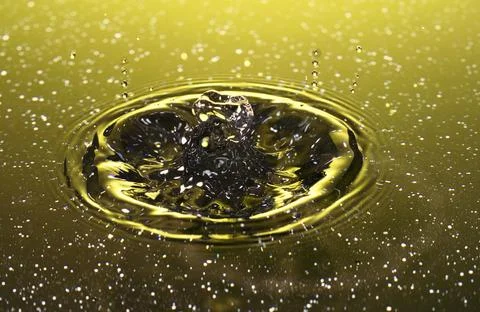 Splash - a falling drop of water in a macro photography shot Stock Photos