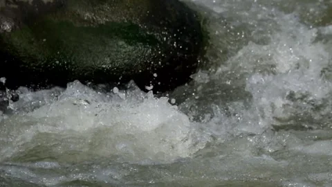 The splash of fast river water over the rocks Stock Footage 292840192
