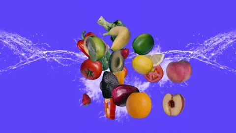 A splash of fresh fruits and vegetables on an isolated bright blue background. Stock Footage 276217543