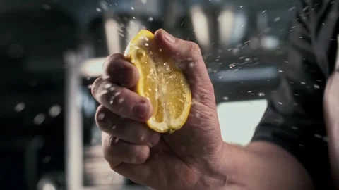 Splash of fresh lemon juice from a slice of real lemon is squeezed by a chef Stock Footage 314577118