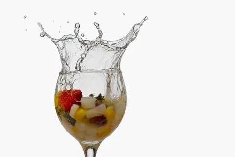 Splash fruit cocktail on white background Stock Photos