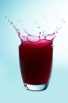 Splash on a glass of raspberry juice Stock Photos
