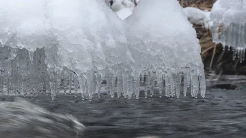 Splash ice Rippling water on tree and branch in Montreal River Hurley Wisconsin Stock Footage 232373946