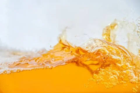 Splash of orange juice with bubbles and foam on surface Foto stock
