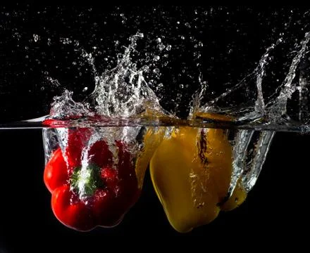 Splash peppers Stock Photos