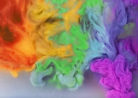 Splash of rainbow colors inks on grey background Foto stock