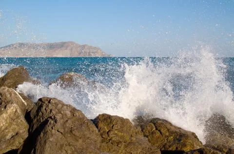 A splash of sea waves on the coast near the stones. Stock Photos